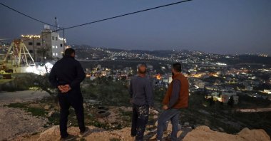 Palestinians stand guard in Huwara, in the occupied West Bank, Palestine, Feb. 28, 2023. (AFP Photo)