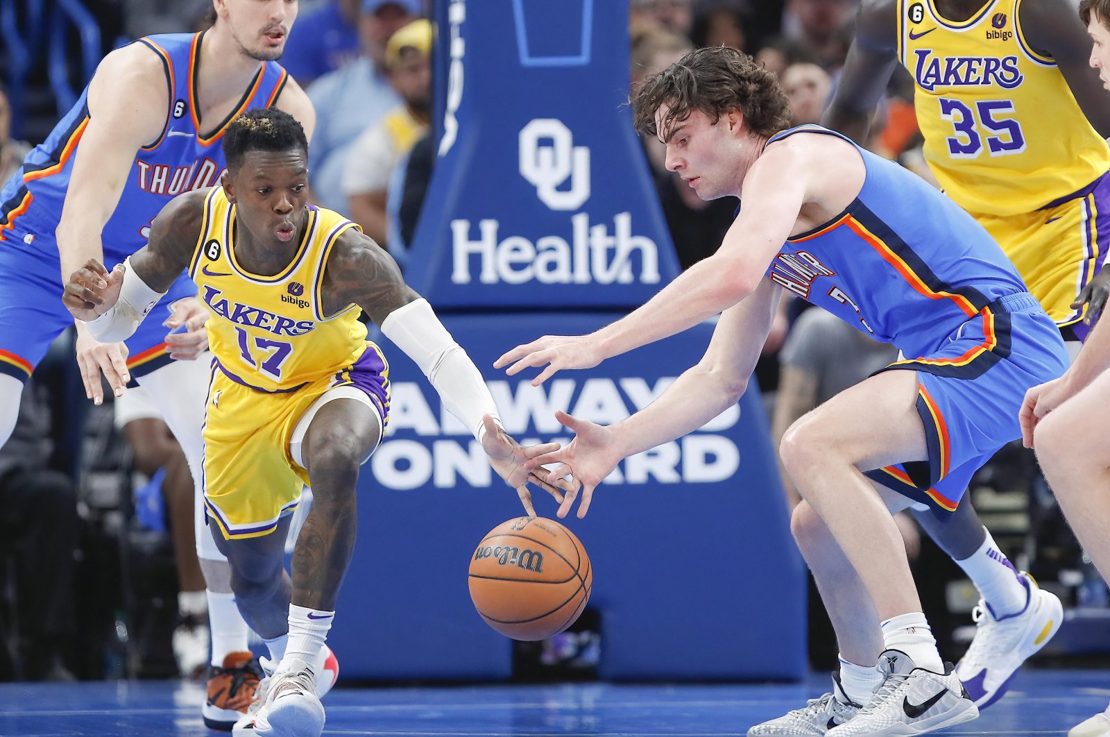 Los Angeles Lakers guard Dennis Schroder (L) and Oklahoma City Thunder guard Josh Giddey (R) attempt to get a loose ball  during the second half at Paycom Center, Oklahoma, US., March 1, 2023. (Reuters Photo)