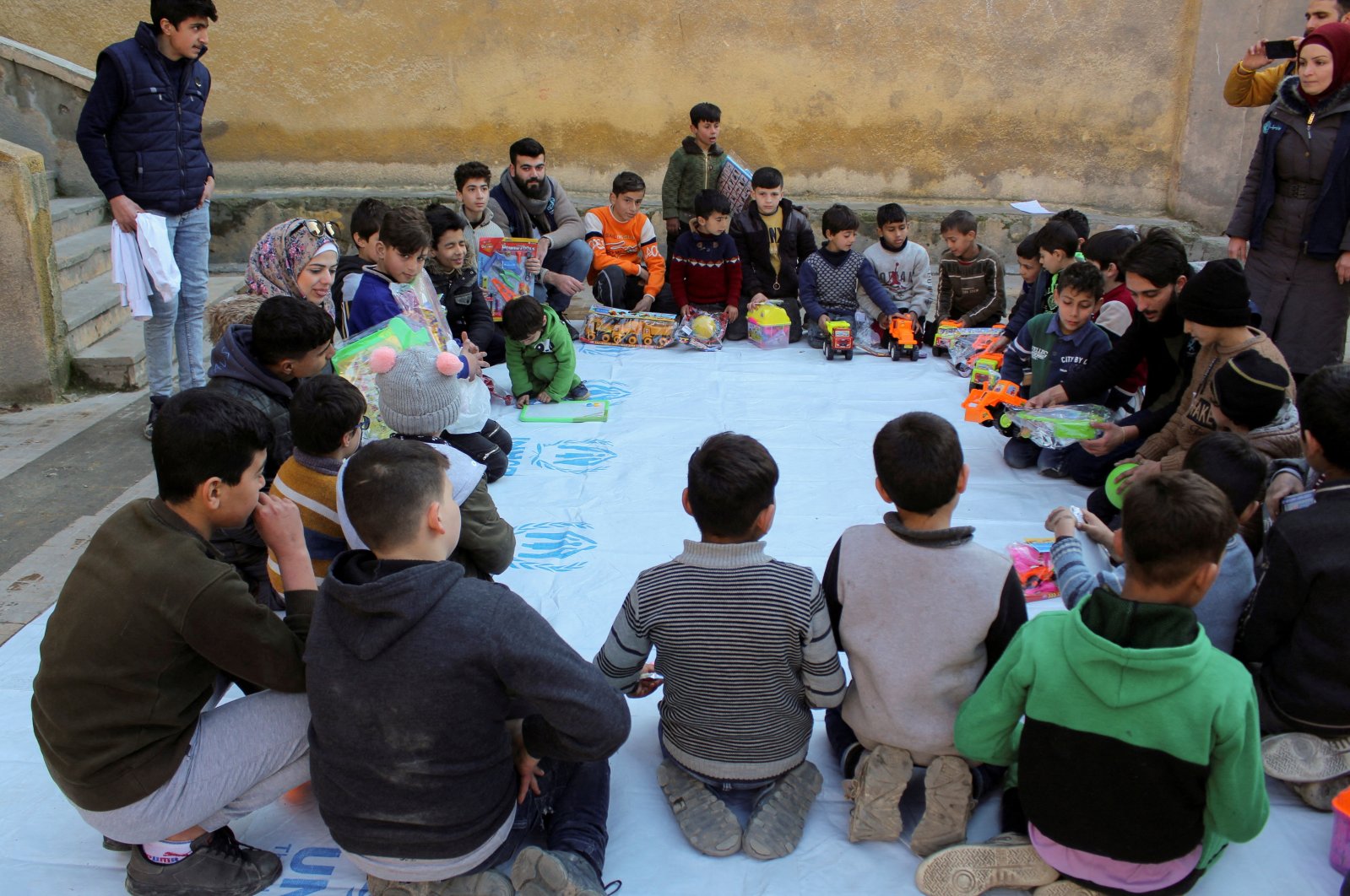 UNICEF volunteers play with children at a makeshift shelter in a school run by UNICEF where psychological first aid is provided, in the aftermath of a deadly earthquake in Aleppo, Syria Feb. 13, 2023. (Reuters File Photo)