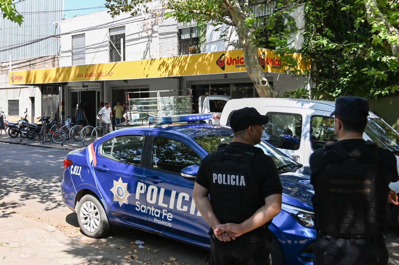 Police officers stand guard outside a supermarket that belongs to the family of Antonela Roccuzzo, wife of Argentine football star Lionel Messi, after two people on motorcycles attacked it and left a threatening message for Messi and the city mayor, Pablo Javkin, in Rosario, Argentina, March 2, 2023. (Reuters Photo)