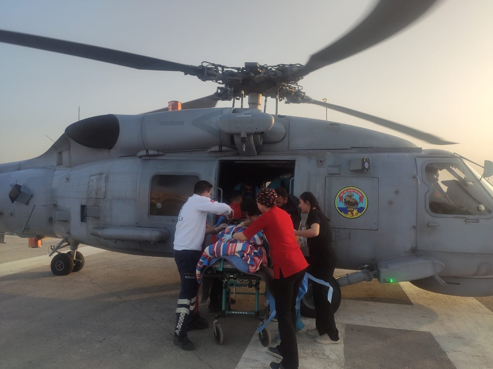 Turkish Armed Forces (TSK) personnel help a patient injured in the earthquakes onto an SH-70 Sea Hawk helicopter for transfer to Adana from Hatay, Türkiye, March 1, 2023. (AA Photo)