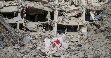 A child's teddy bear lies muddied in the ruins of buildings destroyed by two powerful earthquakes in southern Hatay province, Türkiye, March 1, 3023. (AA Photo)