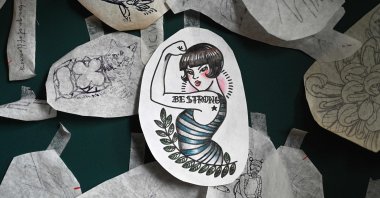 Tattoo templates hanging on the wall of the studio of Chinese tattoo artist Song Jiayin in Beijing, China, Feb. 27, 2023. (AFP Photo)