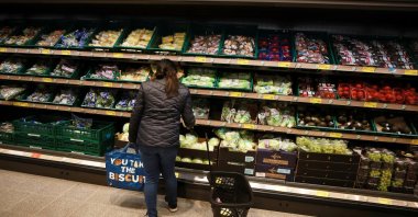 A shopper looks at fruit and vegetables inside an ALDI supermarket near Altrincham, Britain, Feb. 20, 2023. (Reuters Photo)