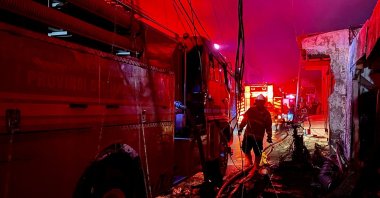 Firefighters extinguish fires that burn down homes of residents living nearby the fuel depot in Plumpang, Jakarta, Indonesia, March 3, 2023. (AFP Photo)