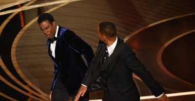 Will Smith (R) slaps Chris Rock onstage during the 94th Oscars at the Dolby Theatre in Hollywood, California, U.S., March 27, 2022. (AFP Photo)