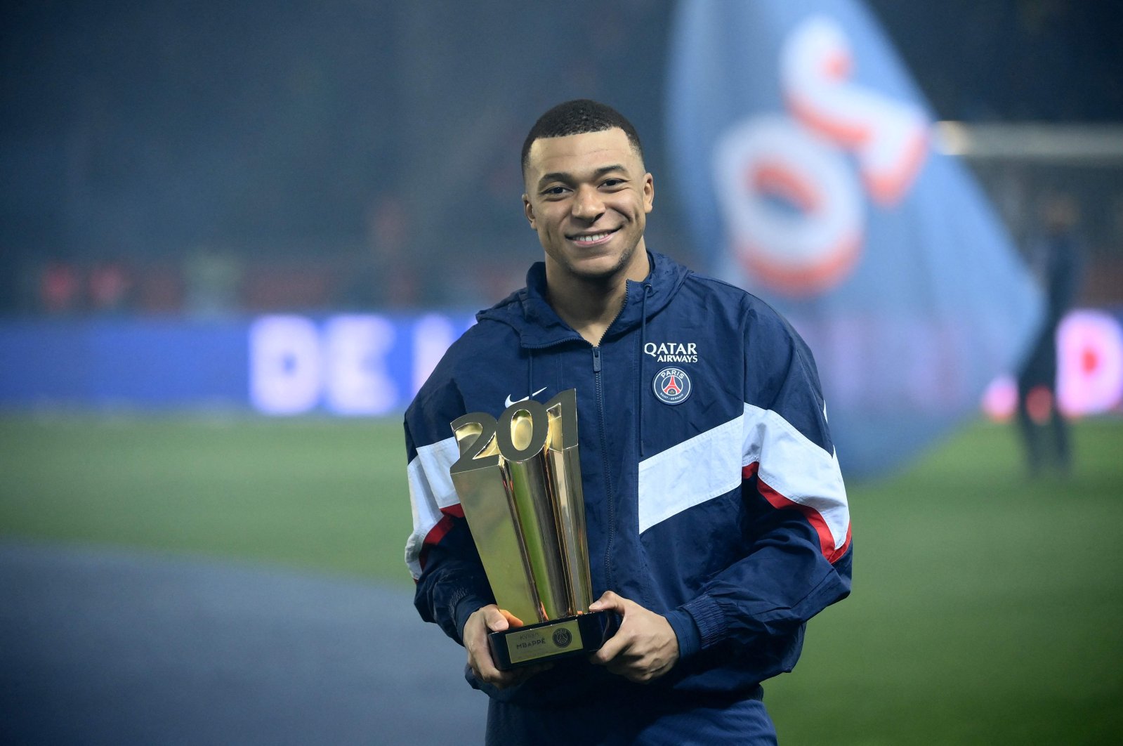 Kylian Mbappe poses with a trophy at the end of a ceremony after he became Paris Saint-Germain&#039;s all-time top scorer with his 201st goal for the club in their 4-2 win in the French L1 football match against FC Nantes at The Parc des Princes Stadium, Paris, France, March 4, 2023. (AFP Photo)
