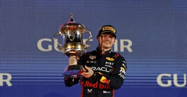 Red Bull's Max Verstappen celebrates on the podium with a trophy after winning the Bahrain Grand Prix Formula One at the Bahrain International Circuit, Sakhir, Bahrain, March 5, 2023. (Reuters Photo)