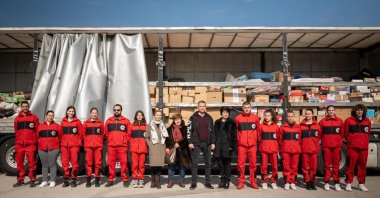Volunteers and officials from the Red Cross Society of Bosnia-Herzegovina and the United Women's Association pose in front of a truck loaded with aid materials collected for the victims of the Türkiye earthquakes, in the city of Banja Luka, Bosnia-Herzegovina, March 5, 2023. (AA Photo)