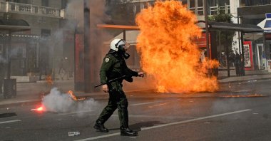 A riot policeman walks past an exploded molotov during a demonstration, Athens, Greece, March 5, 2023. (AFP Photo)