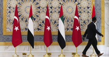 An official walks past Turkish and Emirati flags at Qasr Al-Watan in Abu Dhabi, United Arab Emirates, Feb. 14, 2022. (AP Photo)