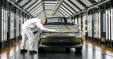 A Volkswagen employee presents a redesigned Volkswagen ID.3 car during a press presentation at the Volkswagen Glaeserne Manufaktur (Transparent Factory) in Dresden, Germany, March 1, 2023. (EPA Photo)