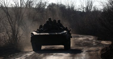 Ukrainian soldiers ride an infantry fighting vehicle along a road not far from Bakhmut, Donetsk region, March 5, 2023, amid the Russian invasion of Ukraine. (AFP Photo)