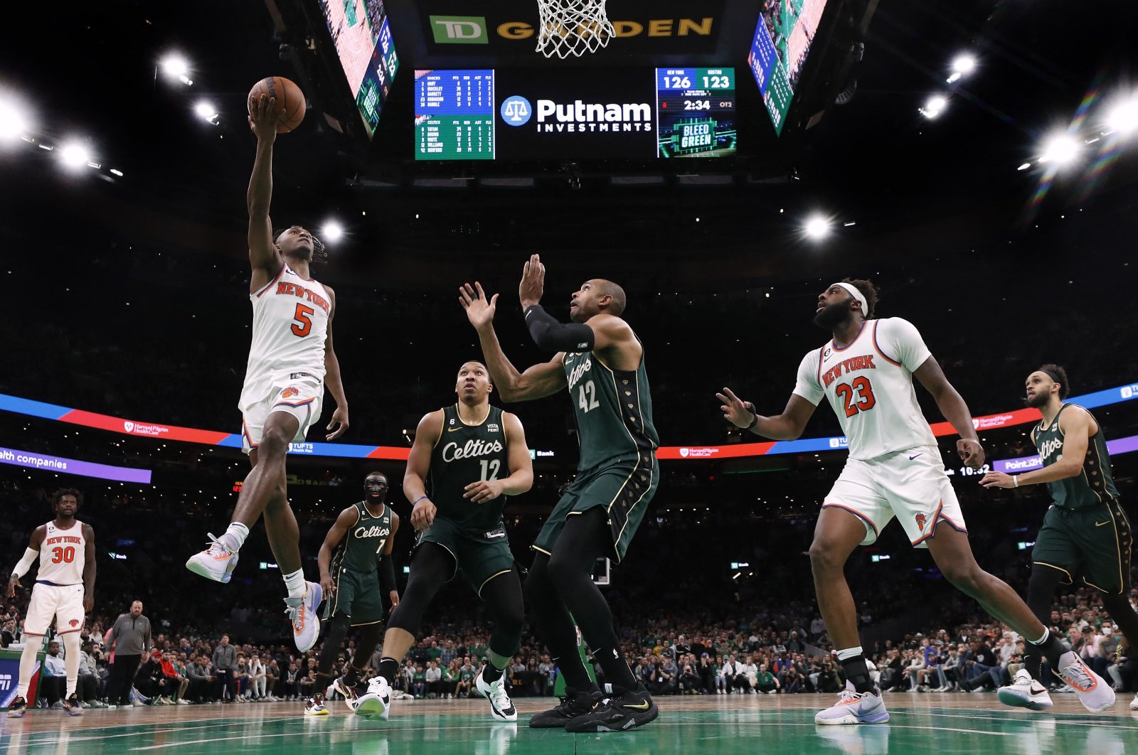New York Knicks guard Immanuel Quickley (L) goes to the basket against the Boston Celtics during the overtime period at TD Garden, Boston, US., March 6, 2023. (Reuters Photo)