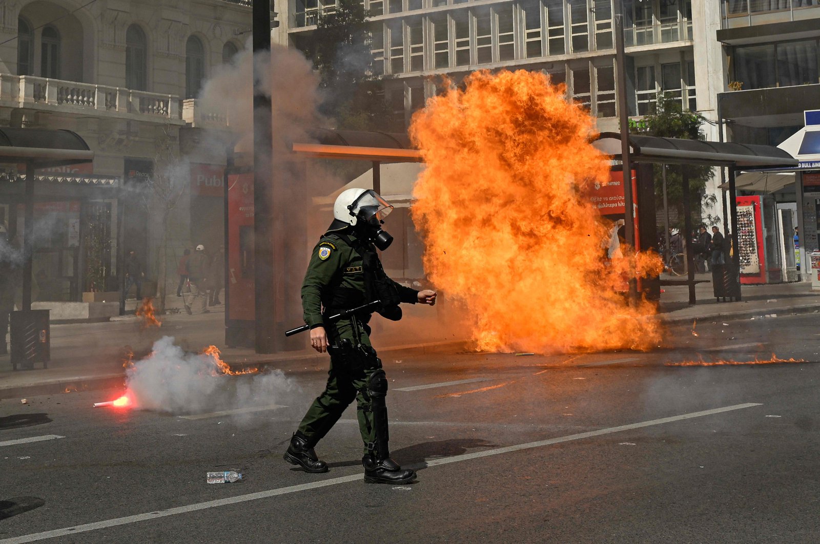 A riot policeman walks past an exploded molotov during a demonstration, Athens, Greece, March 5, 2023. (AFP Photo)