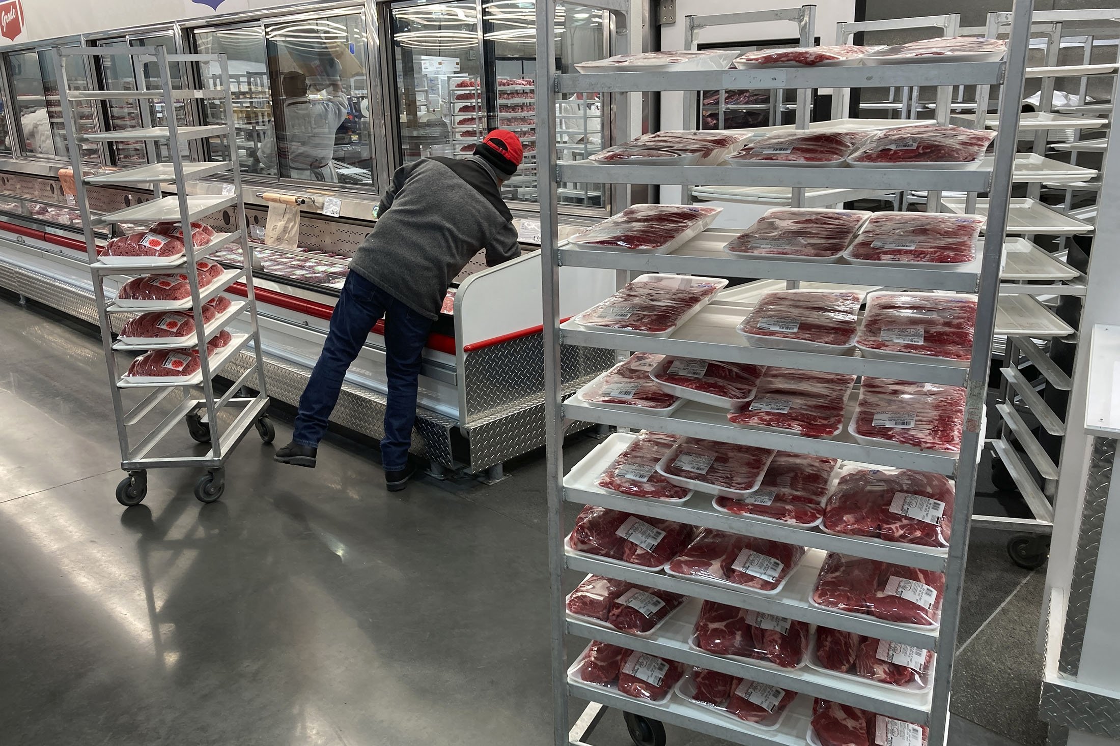 An employee restocks meat, in North Miami, Florida, U.S., Jan. 17, 2023. (AP Photo)