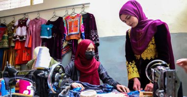 Husna Raoufi (R), a former student of Journalism at Kabul University, works at her tailoring workshop in Kabul, Afghanistan, Feb. 8, 2023. (EPA Photo)