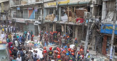 Firefighters inspect the site of an explosion at the Siddique Bazar area in Dhaka, Bangladesh, March 7, 2023. (EPA Photo)