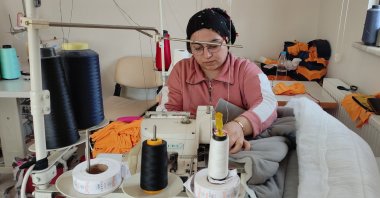 A member of a women's cooperative produces sleeping bags for earthquake victims, Bursa, northwestern Türkiye, Feb. 21, 2023. (IHA Photo)