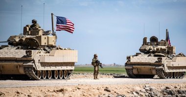 U.S. Bradley Fighting Vehicles (BFV) patrol the countryside of the city of Qamishli in Syria&#039;s northeastern Hassakeh province, April 20, 2022. (AFP Photo)
