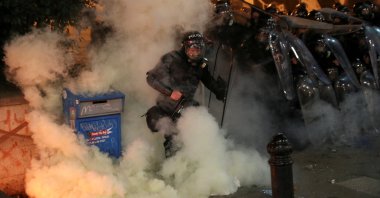 Law enforcement officers take cover during a protest, in Tbilisi, Georgia, March 9, 2023. (Reuters Photo)