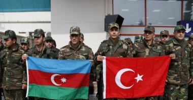 A group of Azerbaijani rescuers pose with the flags of Azerbaijan and Türkiye before the return to their homeland from the earthquake-stricken zone, Türkiye, (IHA Photo)
