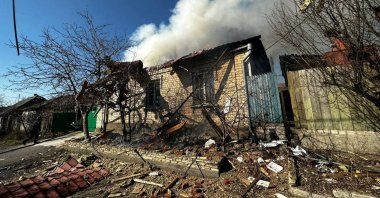 A burning residential house is seen after a Russian military strike, in Kherson, Ukraine, March 9, 2023. (Retuers Photo)