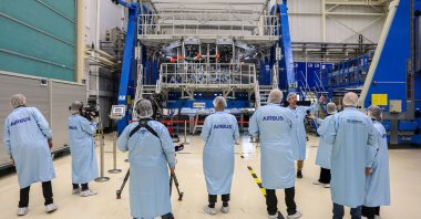 Journalists stand in front of the Orion European Service Module 4 (ESM-4) inside an assembly hall, in Bremen, Germany, Feb. 9, 2023. (AFP Photo)