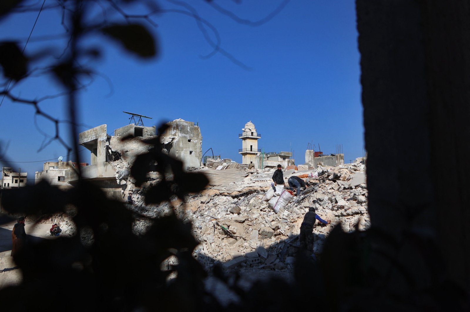Locals shift through the rubble of a collapsed building following earthquakes in Syria&#039;s opposition-held village of Atarib, northwestern Aleppo province, Syria, Feb. 14, 2023. (AFP Photo)