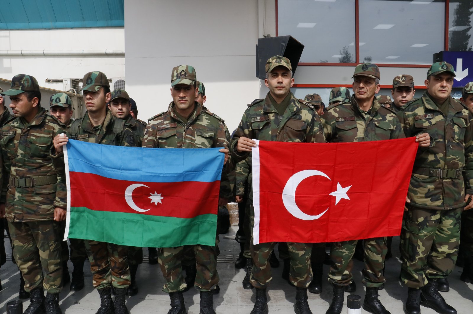A group of Azerbaijani rescuers pose with the flags of Azerbaijan and Türkiye before the return to their homeland from the earthquake-stricken zone, Türkiye, (IHA Photo)