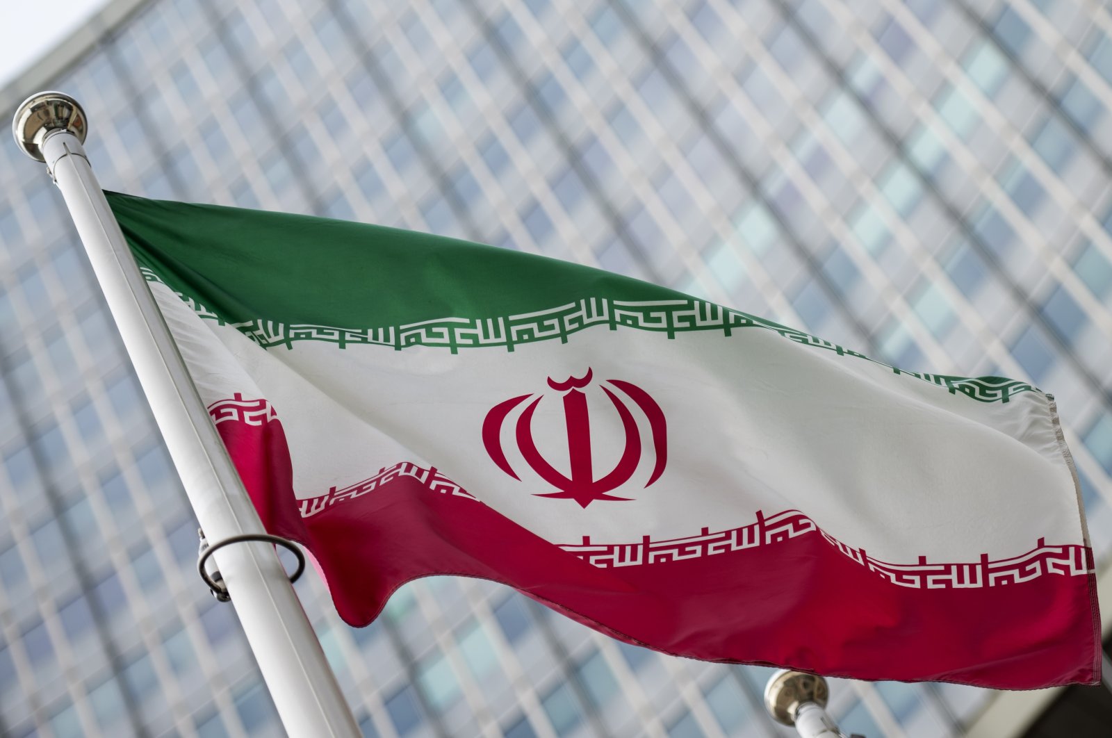 A flag of Iran flies in front of the International Atomic Energy Agency (IAEA) headquarters during a Board of Governors meeting at the IAEA headquarters of the UN seat in Vienna, Austria, March 6, 2023. (EPA Photo)