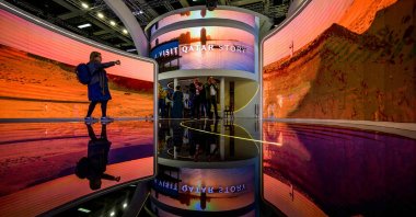 A visitor takes pictures of a multi-screen display at Qatar stand at the International Tourism Trade Fair (ITB, Internationale Tourismusboerse) in Berlin on March 8, 2023. (AFP photo)