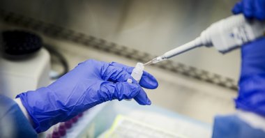 A laboratory technician prepares COVID-19 patient samples for semi-automatic testing at Northwell Health Labs, in Lake Success, March 11, 2020. (AP File Photo)