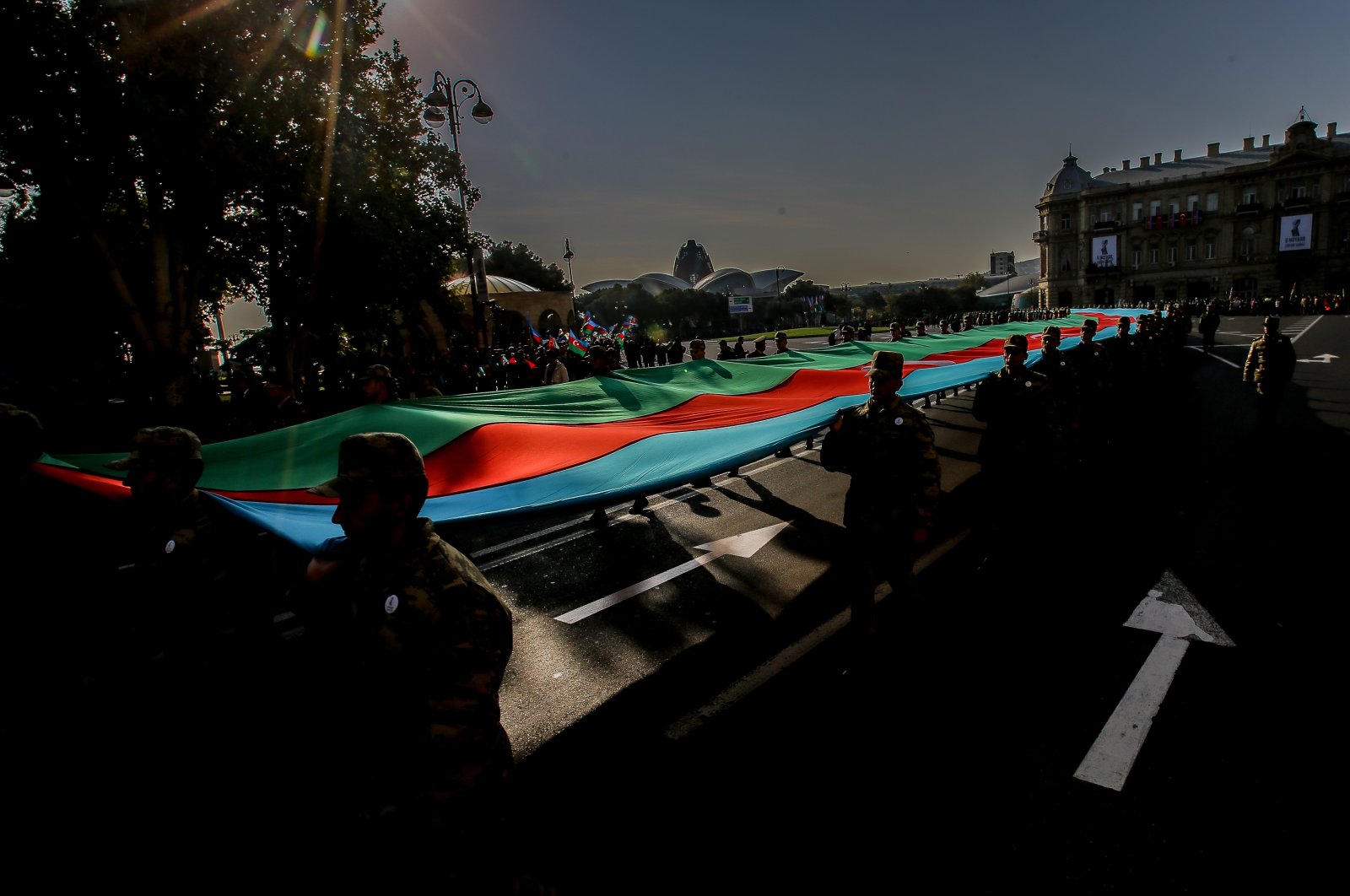 Azerbaijani service members carry a giant flag during a procession marking the anniversary of their victory in the 2020 military conflict over the Karabakh region, Baku, Azerbaijan, Nov. 8, 2021. (Getty Images Photo)