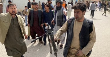 A wounded journalist (R) holds a camera tripod back near the site of a bomb blast during an event commemorating the media in Mazar-i-Sharif, Balkh, Afghanistan, March 11, 2023. (AFP Photo)