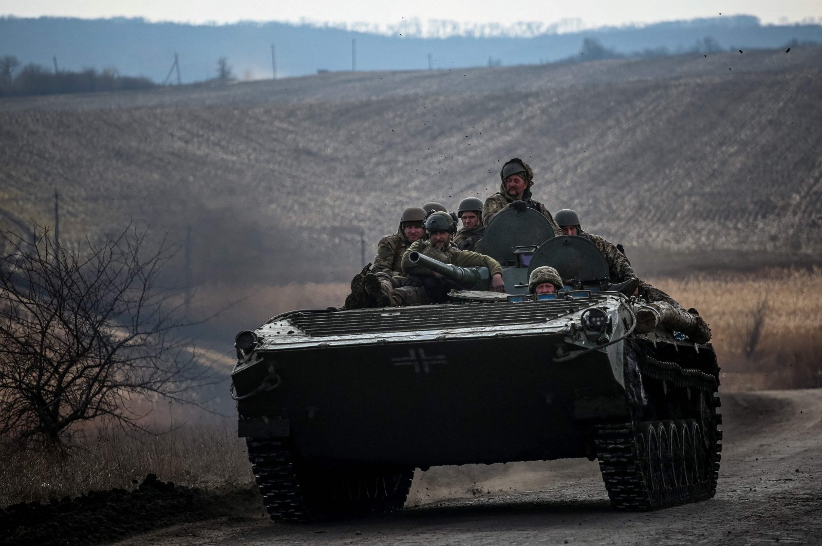 Ukrainian servicemen ride atop a tank near the frontline city of Bakhmut, Ukraine, March 10, 2023. (AFP Photo)