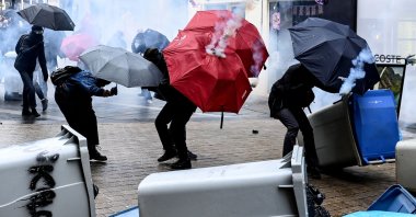 Protesters use umbrellas as protection against tear gas, Nantes, western France, March 11, 2023. (AFP Photo)