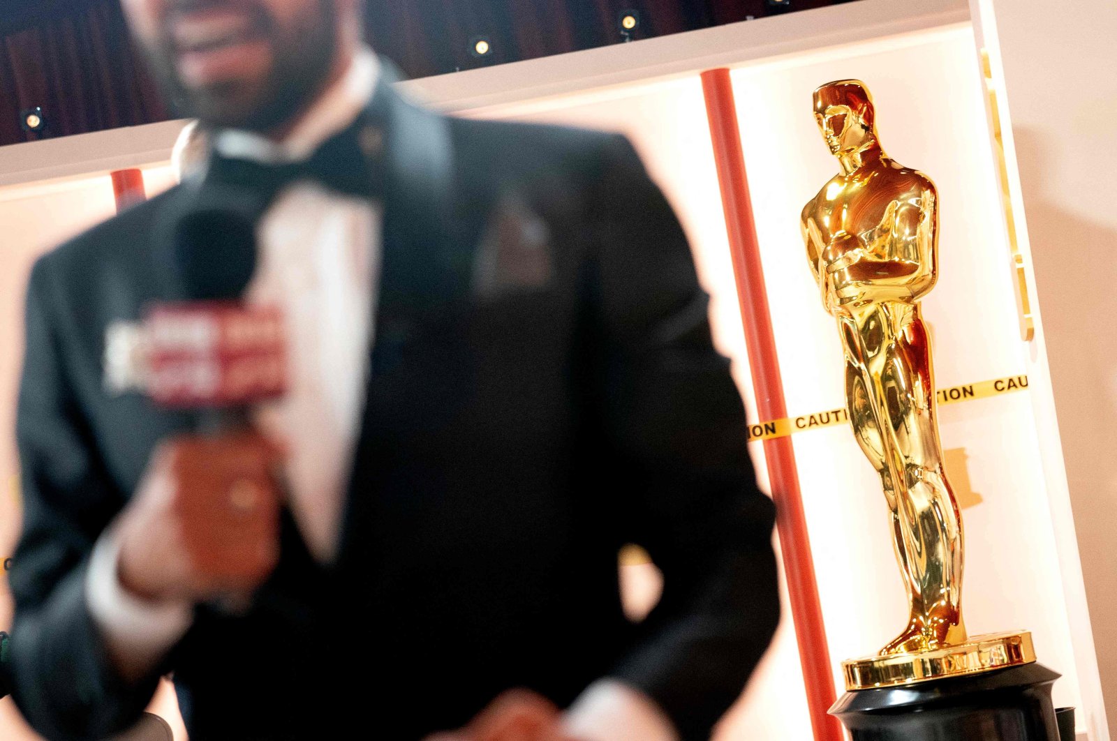A member of the media speaks to camera near a decorative Oscar statue as final preparations are made for the 95th Academy Awards, in Hollywood, Los Angeles, California, U.S., March 11, 2023. (AFP Photo)