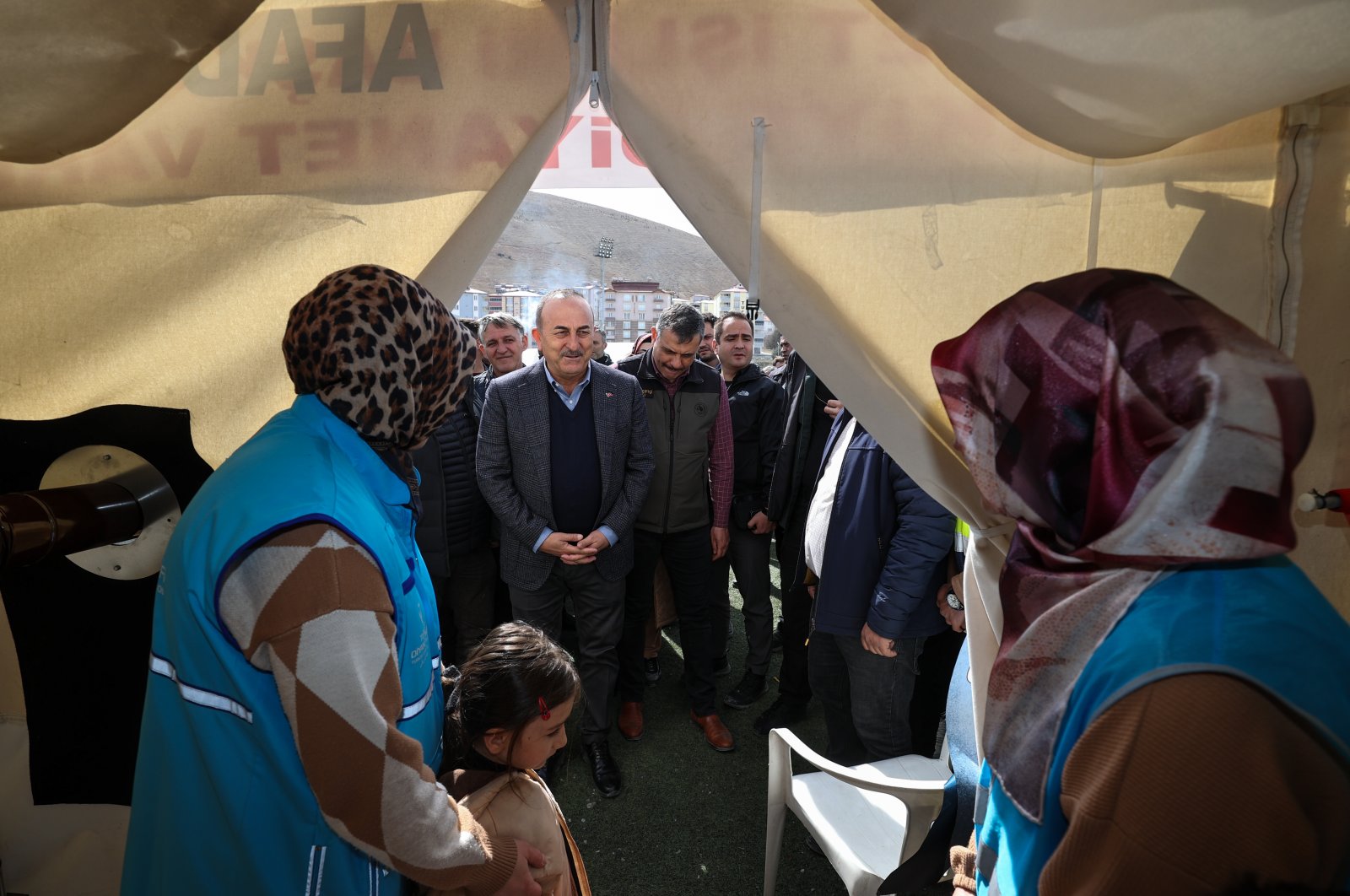 Foreign Minister Mevlüt Çavuşoğlu visits a family staying in a tent after being displaced by the Feb. 6 earthquakes in the Afşin district of Kahramanmaraş, southern Türkiye, March 11, 2023. (AA Photo)