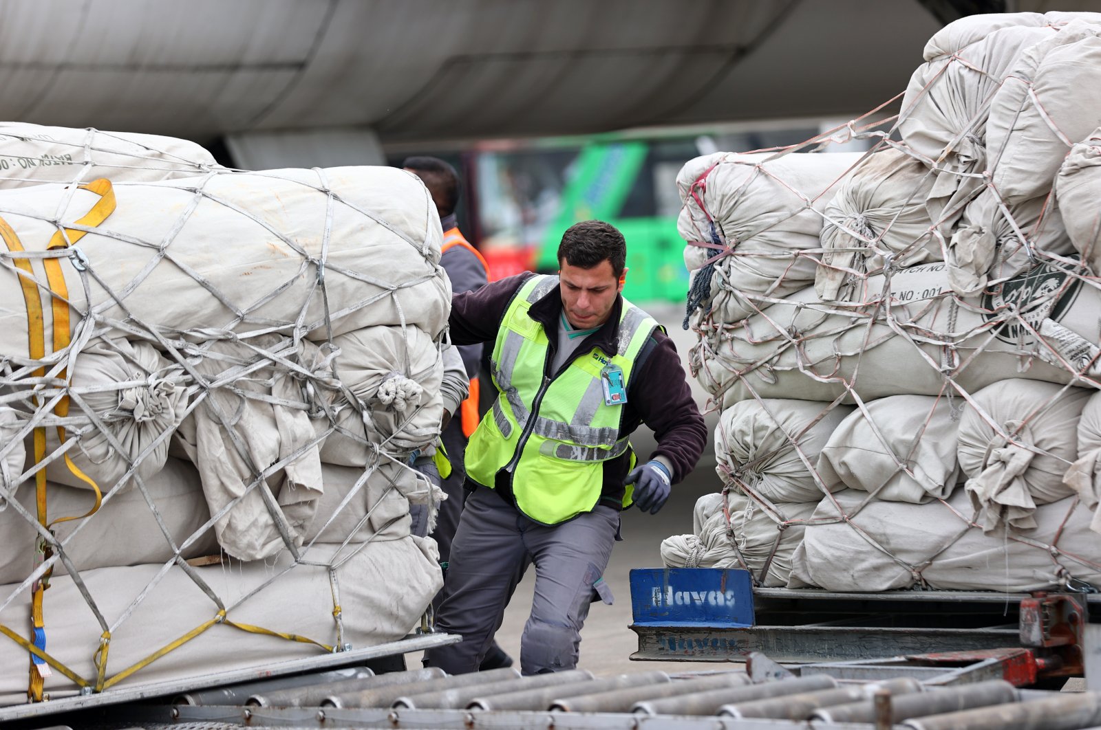 An airport worker pushes a crate of humanitarian aid that arrived from Pakistan for earthquake victims in Adana, Türkiye, March 12, 2023. (AA Photo)