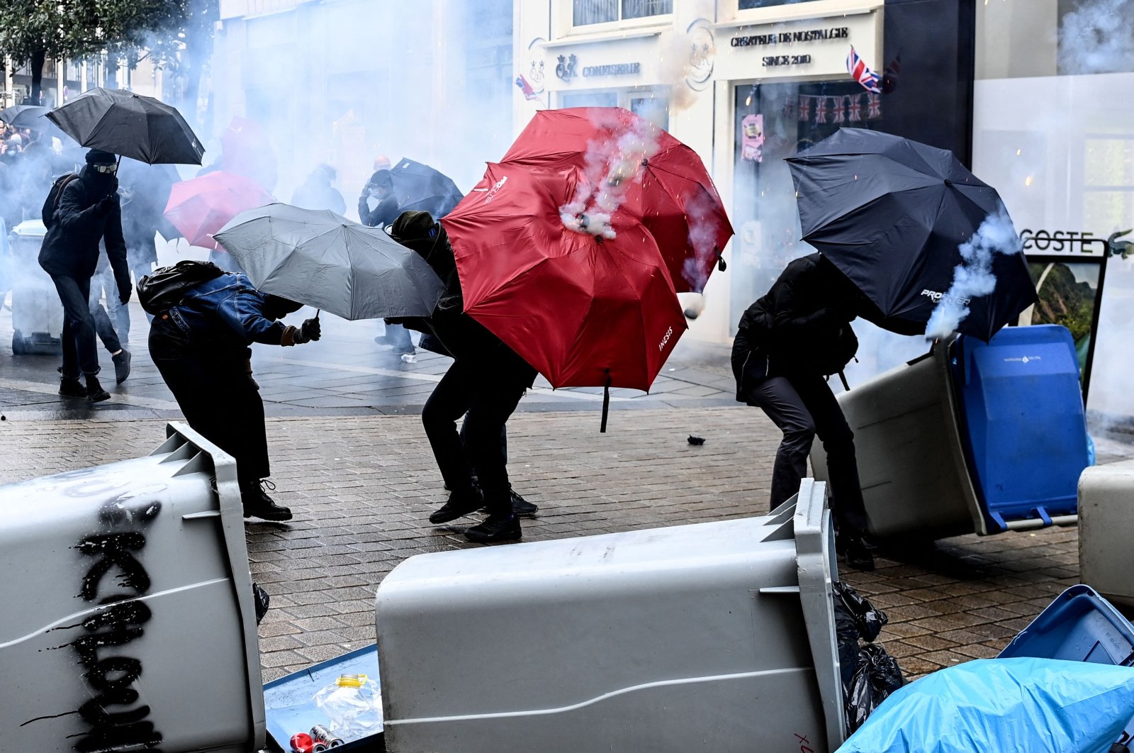 Protesters use umbrellas as protection against tear gas, Nantes, western France, March 11, 2023. (AFP Photo)