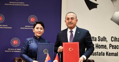 Foreign Minister Mevlüt Çavuşoğlu (R) and his Mongolian counterpart Batmunkh Battsetseg pose with protocol documents of three agreements they signed at a meeting in the capital Ankara, Türkiye, March 13, 2023. (AA Photo)