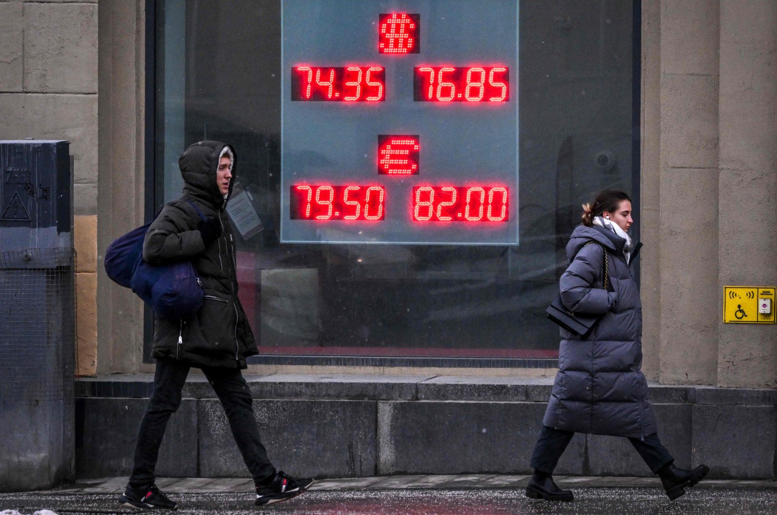 Pedestrians walk past a board at a currency exchange office in Moscow, Russia, Feb. 16, 2023. (AFP Photo)