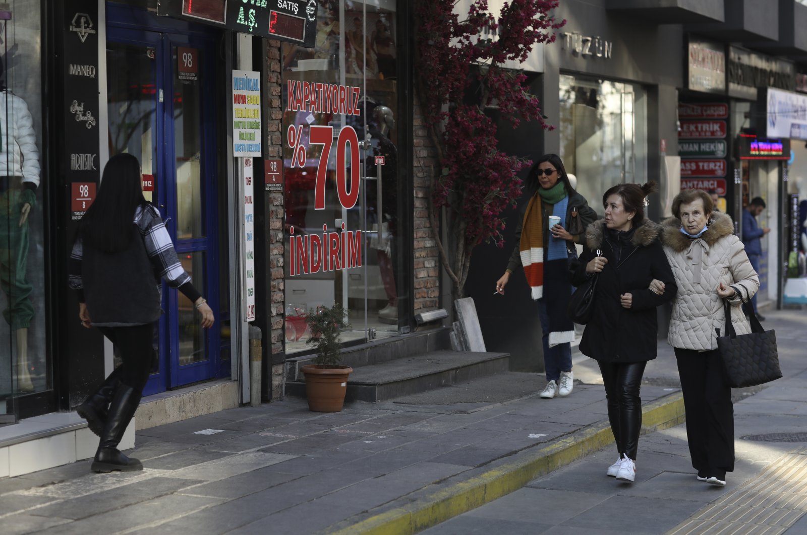 Women stroll at a popular shopping street in the capital Ankara, Türkiye, Jan. 3, 2023. (AP Photo)