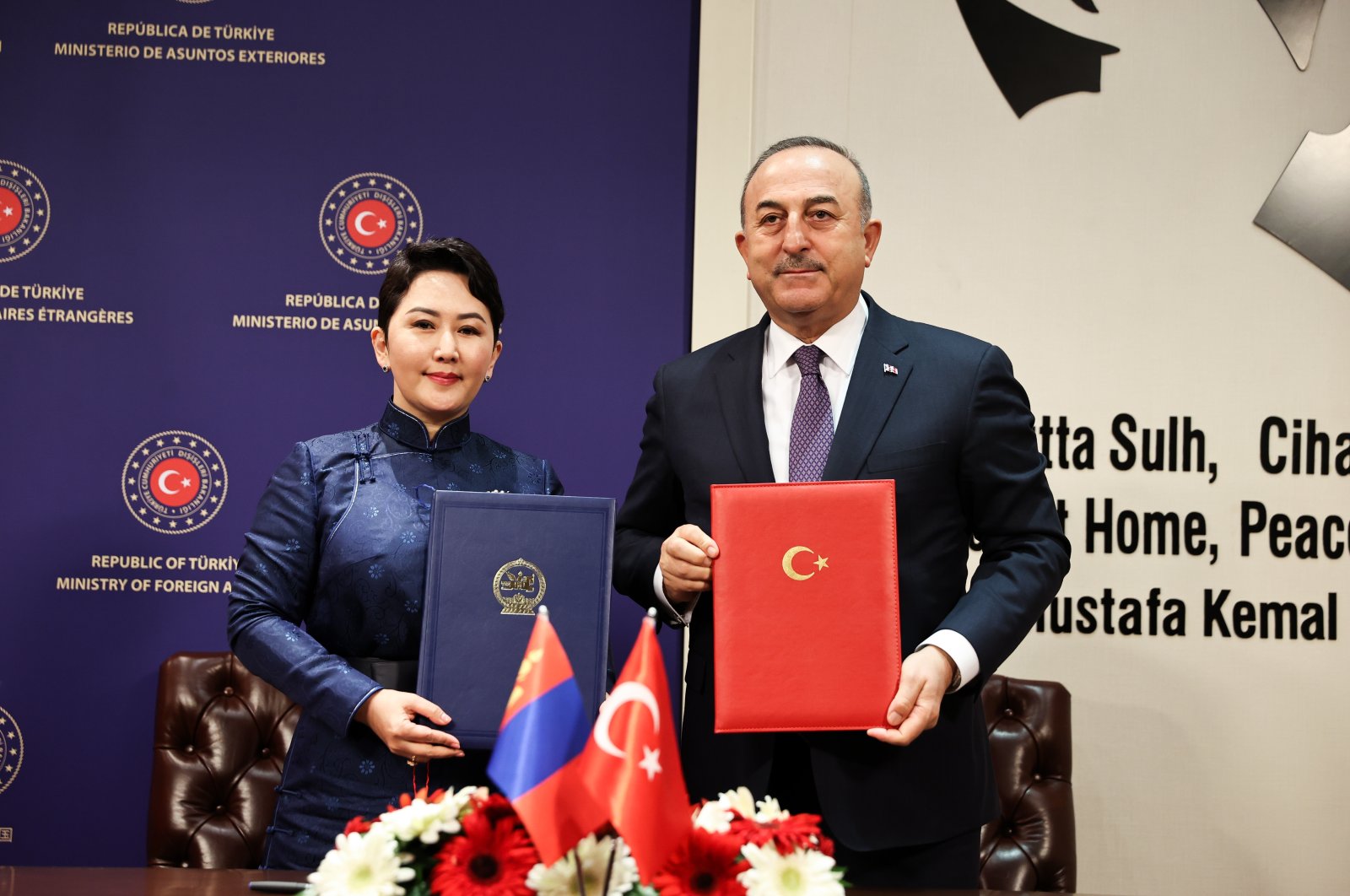 Foreign Minister Mevlüt Çavuşoğlu (R) and his Mongolian counterpart Batmunkh Battsetseg pose with protocol documents of three agreements they signed at a meeting in the capital Ankara, Türkiye, March 13, 2023. (AA Photo)