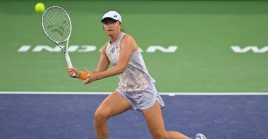 Polish Iga Swiatek hits a shot as she defeated Canadian Bianca Andreescu in her third round match at the BNP Paribas Open at the Indian Wells Tennis Garden, Indian Wells, US., Mar 13, 2023. (Reuters Photo)