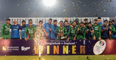 Bangladeshi players pose with the trophy after winning the Twenty20 international cricket series at the end of the third and final match against England at the Sher-e-Bangla National Cricket Stadium in Dhaka, March 14, 2023. (Munir uz ZAMAN/AFP)