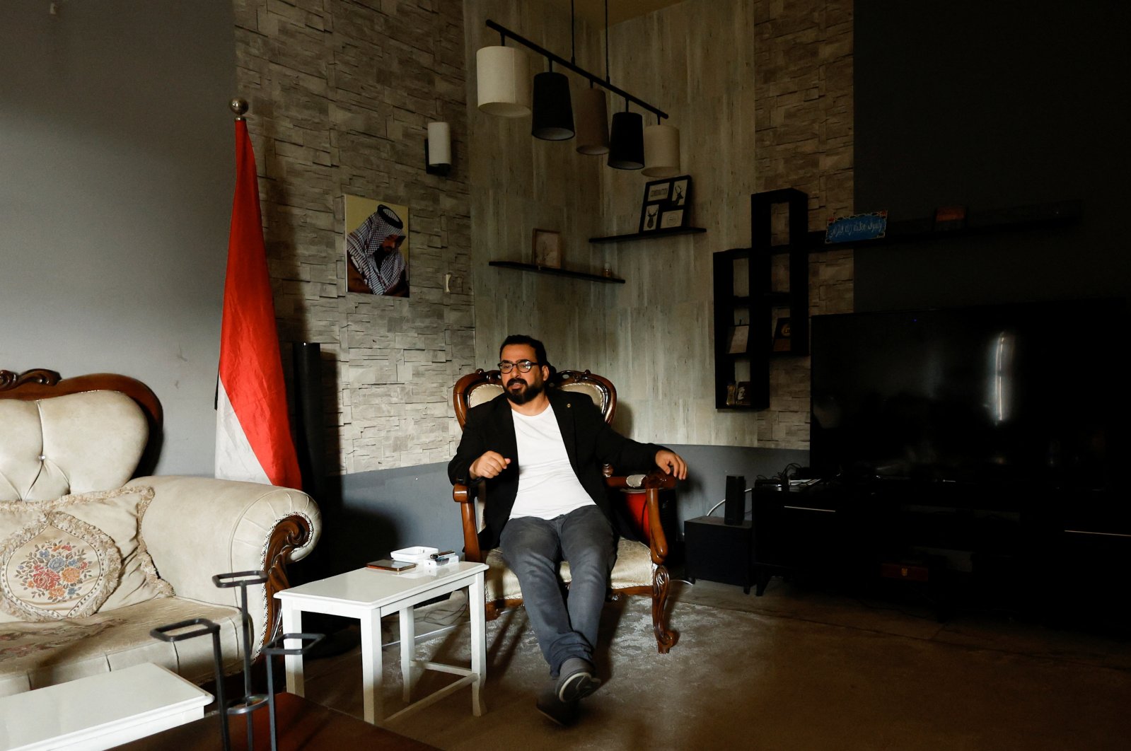 Iraqi journalist Muntadhar al-Zeidi sits at his home in Baghdad, Iraq, March 8, 2023. (Reuters Photo)