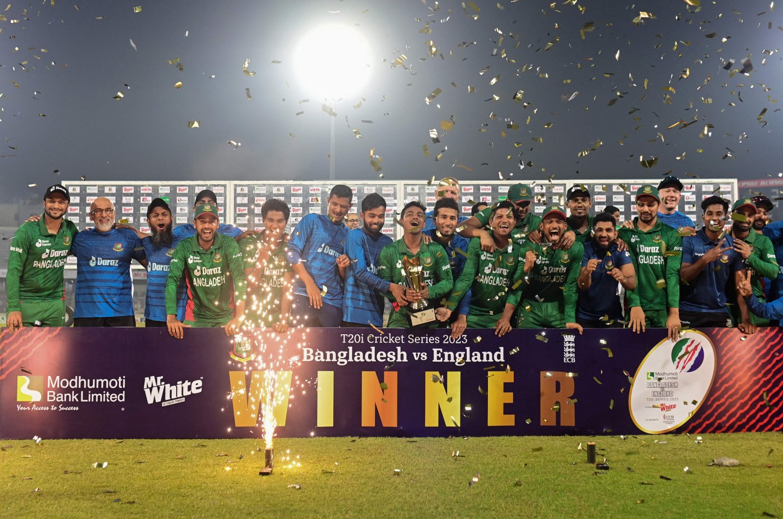 Bangladeshi players pose with the trophy after winning the Twenty20 international cricket series at the end of the third and final match against England at the Sher-e-Bangla National Cricket Stadium in Dhaka, March 14, 2023. (Munir uz ZAMAN/AFP)