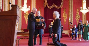 Brian May, musician, songwriter and animal welfare advocate, is made a Knight Bachelor by King Charles III at Buckingham Palace in London, U.K., March 14, 2023. (AP Photo)